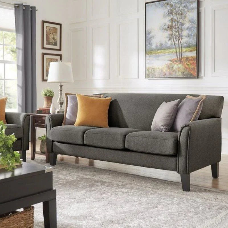 Modern gray fabric sofa with yellow and gray pillows in stylish living room, detailed furniture design